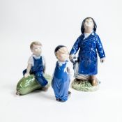 Royal Copenhagen Porcelain figures to include:- Boy with Umbrella No:3556, Boy on a Pumpkin No:4539,