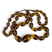 Large clear amber necklace with 38 graduating beads, largest bead 3.75 x 2.75cm and length of