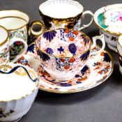 A collection of 19th century porcelain tea cups and coffee cans in various patterns from different