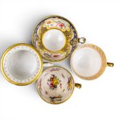 A collection of 18th and 19th century porcelain tea cups in various patterns from different