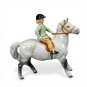 Beswick model of a girl with light green jacket on rare grey pony, model 1499, h.14.25cm.