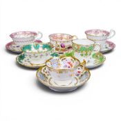 A collection of 19th century porcelain tea cups in various patterns from different manufacturers