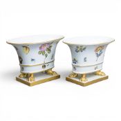 A pair of Herend Porcelain vases depicting hand-painted floral motifs and gilded lion claw feet.