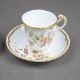 A group of five cups & saucers from various manufacturers, to include a Derby cup & saucer decorated - Image 5 of 7