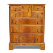 Early 20th century walnut small tallboy with seven drawers and one cupboard, w.61 x d.38 v h.76cm.