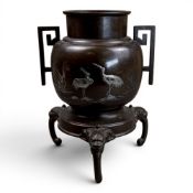 A Japanese bronze tripod vase, Meiji period, decorated with silvered cranes, h.23cm.