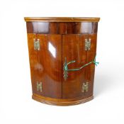 A Georgian mahogany bow fronted corner cupboard with brass hinges, H45cm x W35cm x D24cm. Collection