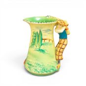 Burleigh Ware Golfing jug, the handle in the form of a golfer wear green jumper. (H: 19.5cm)