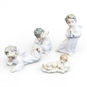 Lladró porcelain figurines featuring Angel with Flute, model no.4540, Angel Laying Down, model no.