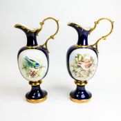 A pair of 19th century Caverswall Bone China decorative ewers, featuring hand-painted bird artwork
