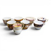 A collection of 18th and 19th century porcelain tea cups in various patterns from different
