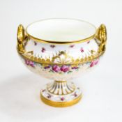 Cauldon English pedestal bowl with twin handles decorated with heavy gilt design with delicate blush