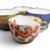 A collection of 18th and 19th century porcelain tea cups in various patterns from different