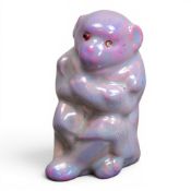 Bernard Moore Flambe seated monkey with arms folded, glass eyes, decorated with red, purple and pink