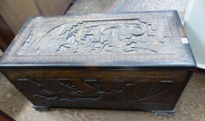 A profusely carved camphor wood trunk 93cm W x 44cm D x 50cm H