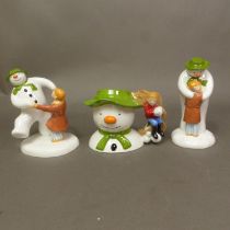 Three boxed Coalport Characters The Snowman figurines The Hug, Dancing at the Party and Snowman