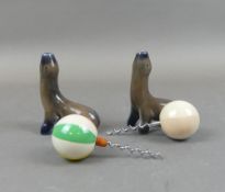 Two Wade Corkscrews in the form of Seals, each with a Ball, app height 14cm.(2) one chipped