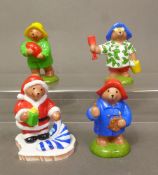Four boxed Coalport Characters 'Paddington Bear' figurines, Father Christmas, The Artist, Beach Bear