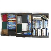 A large quantity of VHS tapes together with a collection of empty cassette boxes. Collection/courier