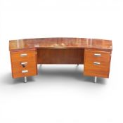 1970's presidents desk, featuring distinctive curved desk, reddish-brown wood top with multiple