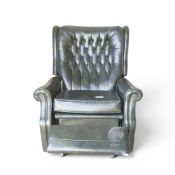 Sklar dark green leather recliner chair with manual extendable footrest mechanism. COURIER OR