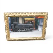 A large Wall Mirror in a gilt effect frame. total measurement 83cm x 60 cm.