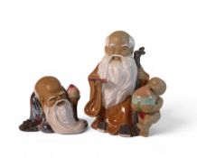 Two Chinese ' Mud med ' figures, to include Shiwan and man with a child, tallest 20cm, (2)