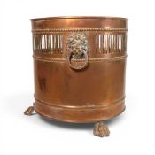 A copper Planter , three footed with Lion ring handles, height 31cm, small buckle above one foot,