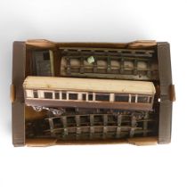 A quantity of gauge 1 track, together with long wooden passenger carriage in GWR livery, and freight