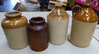 Group of four stoneware flagons/jars including an example lettered 'Bucktrout & Co Ltd Guernsey',