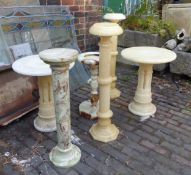 A group of six alabaster and green onyx display plinths, torcheres, bird bath and side tables (6).