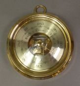 Barigo brass-cased aneroid barometer with visible movement, diameter 20cm.