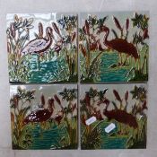 Four early 20th-century fireplace/wall/floor tiles depicting herons, 15cm x 15cm x 1cm (1 tile re-