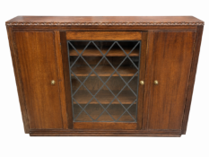 A dark oak Jaycee style glazed wall cabinet with diamond-latticed glass and decorative side moulding