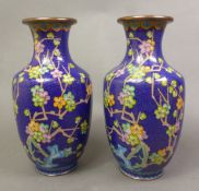 Pair of Chinese cloisonné vases vibrant enamel decoration depicting prunus blossoms on a cobalt blue