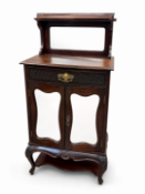 A late Victorian mahogany side cabinet with shaped mirrored doors and upper mirrored display shelf