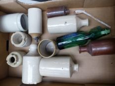 A collection of antique stoneware bottles, a glass bottle and a clay pipe (1 tray).