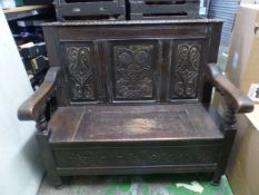 Oak bench/settle with storage below, carved details, width 115cm.