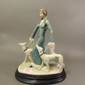 Vintage signed A.D.L. A Berni resin sculpture of a lady walking two dogs, raised on a wooden plinth,