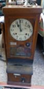 National Time Recorder Company Ltd, an early 20th century oak-cased National clocking-in clock, with