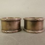 Pair of Walker & Hall silver-plated napkin rings, military issue with broad arrow/crows foot mark,