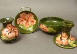 Moorcroft Hibiscus pattern on green ground items to include bowl, small dish, small vase &