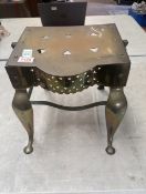 19th century brass footman, featuring delicate heart-shaped cutouts on the the apron, with