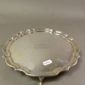 Sterling silver salver raised on four supports, Sheffield 1966, with inscription, 542g.