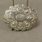 A Turkish 900 silver flowerhead wedding mirror, all over relief embossed decoration, max diameter