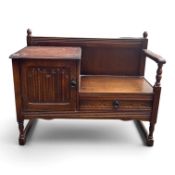 Linen fold dark oak telephone seat with single drawer and cupboard storage. (H: 78cm x W: 98cm)