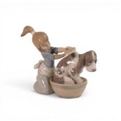A Lladro figure 'Bashful Bather Dog' model number 5455, Height 12.5cm.