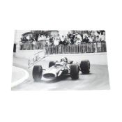 Black and white press photograph of Formula One driver Jack Brabham, racing at the Monaco GP, with