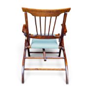 Edwardian style folding oak campaign chair, with spindle back and green fabric upholstered seat.