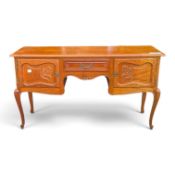 French-style carved oak writing desk on tall cabriole legs with central drawer and 2 cupboards. (